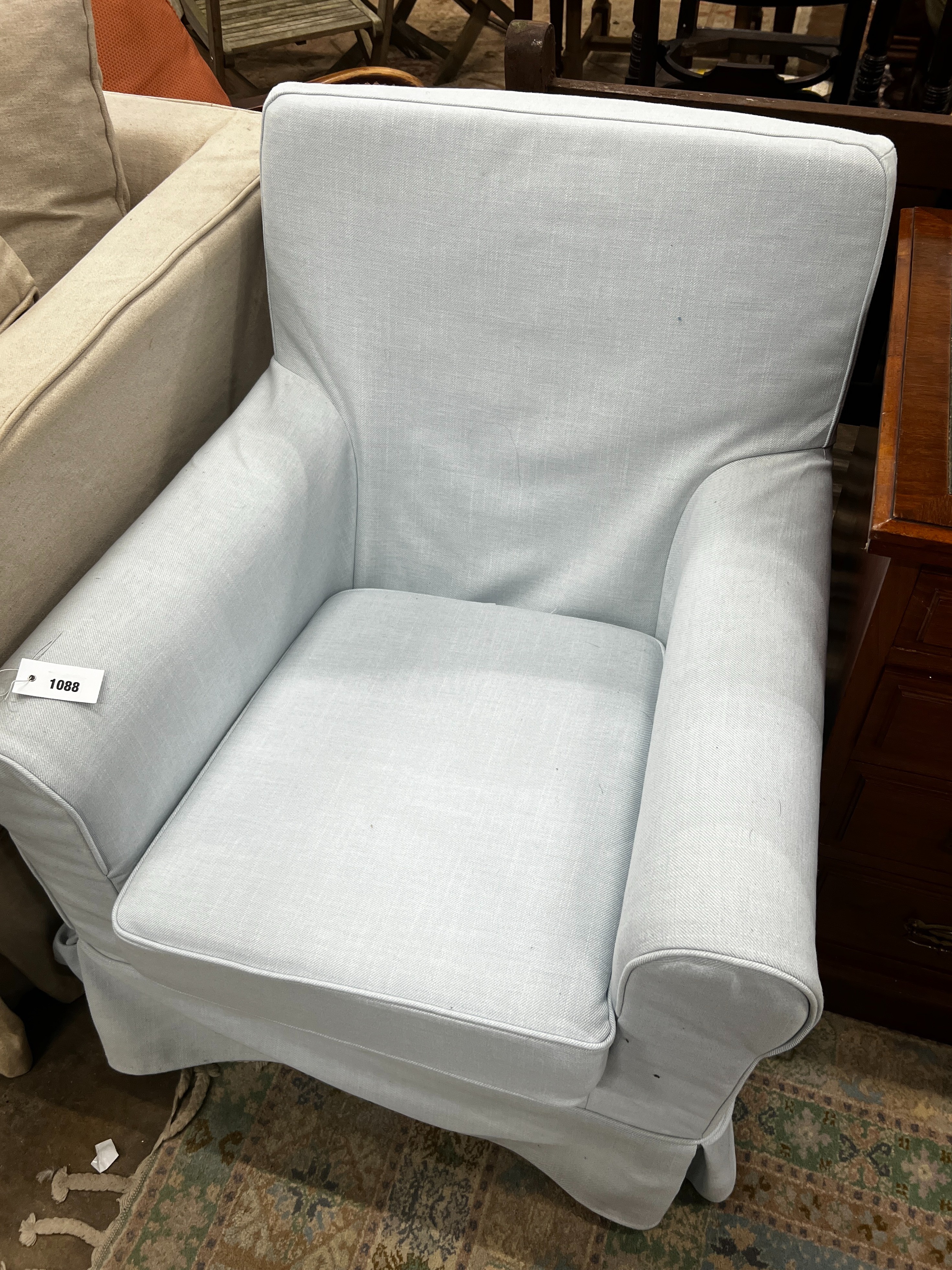 A Laura Ashley armchair upholstered in a pale blue fabric, length 76cm, depth 65cm, height 86cm